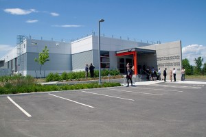 Colour photograph of the exterior of a building. Front: Parking lot area; Back: Main entrance to the building