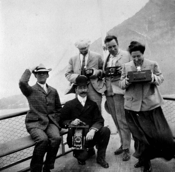 Possibly members of the Benjamin Low family on a passenger steamer showing various types of cameras, including a panoramic camera, 1904.
