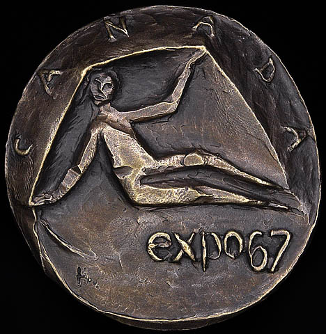 Photograph of a bronze medal showing a stylized image of a person sitting down, inscribed with the words “Canada” along the top edge and “expo 67” on the bottom right.