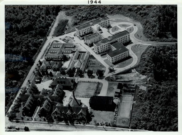 A black-and-white aerial view of a building complex.