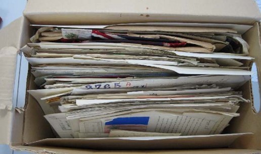 An open container showing textual material ready to be assessed.