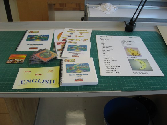 A colour photograph showing a multimedia kit containing a variety of items spread across a worktable. 