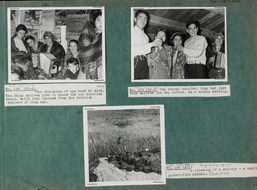 Photograph of a green album page with three black and white photographs (numbered 158, 159, and 160) with typed captions on white paper. The photograph in the top left corner is of women and children sitting in front of several wooden crates labeled “Marven’s Biscuits” and one marked “H.B.C. Wholesale Vancouver.” The photograph in the top right corner is of two couples dancing while a woman plays the accordion. The photograph at the bottom of the page is of an Arctic ground squirrel in a grassy field with a rock in the foreground.