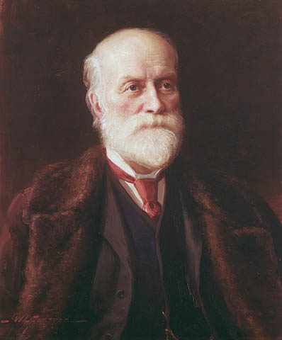 An oil painting of an older man with a white beard wearing a dark suit with a red cravat and a brown fur coat.