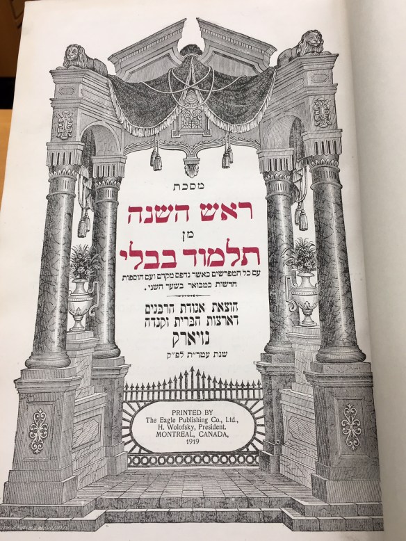 A colour photograph of an open book showing Hebraic writing.