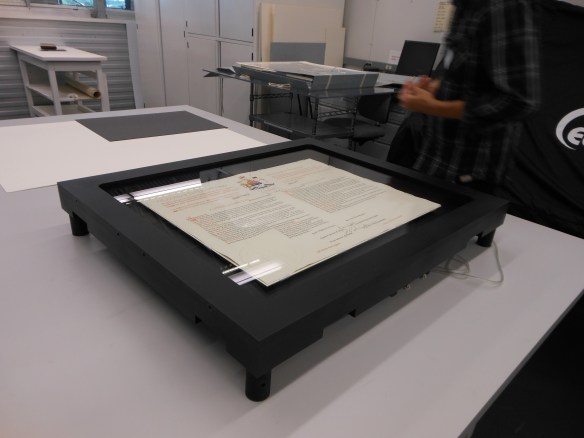 Four-legged black case with glass window showing the Proclamation. 