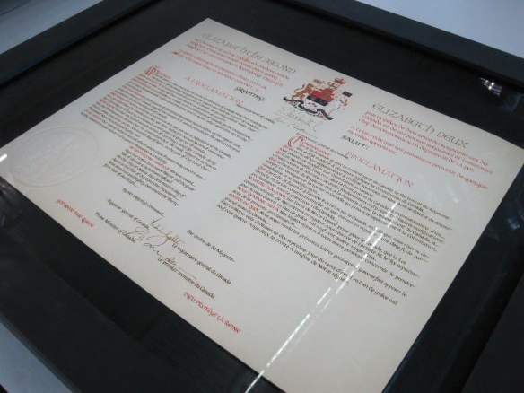 Close up of the preservation case displaying a copy of the Proclamation under glass in a black frame.