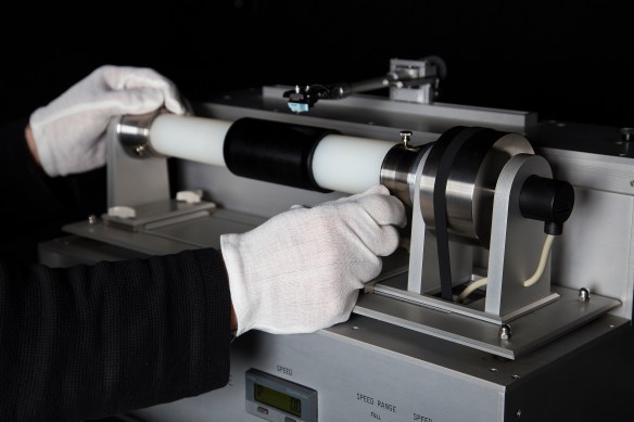 A colour photograph of a cylinder player with a Blue Amberol cylinder on a horizontal tube and the needle hovering above the cylinder.