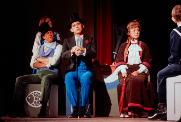 A colour photograph of actors in costume on a stage.