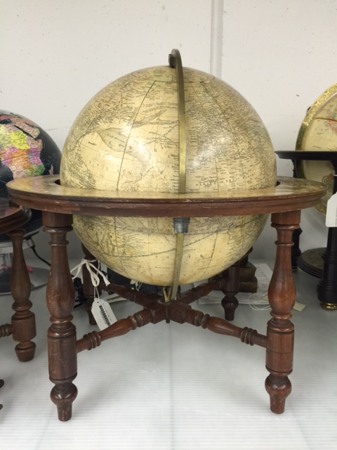 A large globe in a wood and brass stand.