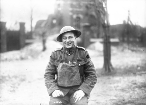 A black-and-white photograph of a smiling soldier wearing a helmet and a leather jerkin.