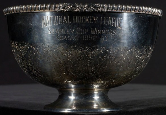 A colour photograph of a copper silver-plated bowl engraved with “National Hockey League, Stanley Cup Winners, Season 1952–53.”