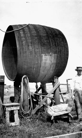 A black-and-white photograph of a Pelee Island wine vat now used as a water reservoir. 