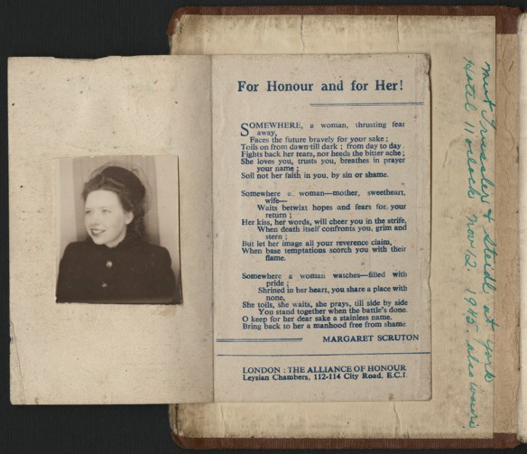 A colour photograph of a book opened at the first page. A pamphlet has been glued on the inside cover which has a photograph on one side and an ode to the women who stayed home entitled “For Honour and for Her!”