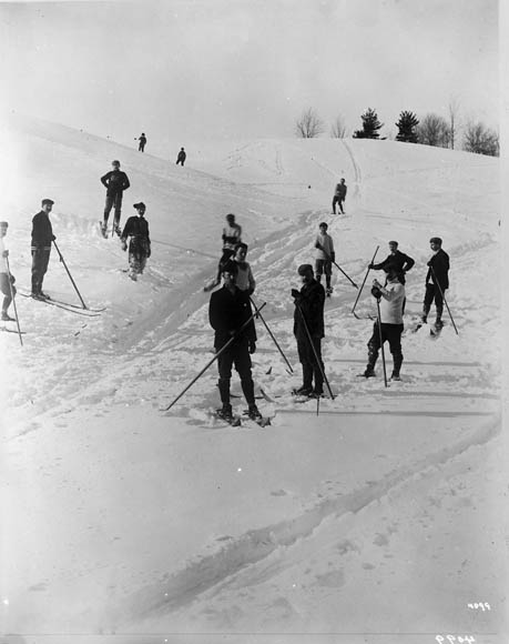 A black-and-white photograph of people skiing.