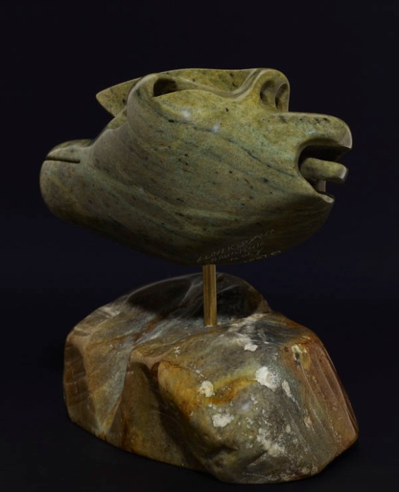 A colour photograph of the side of a stylized sculpture of a man.