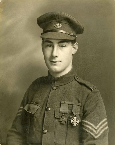 A sepia photograph of a soldier in uniform with a Victoria Cross and a Croix de Guerre pinned to his chest.