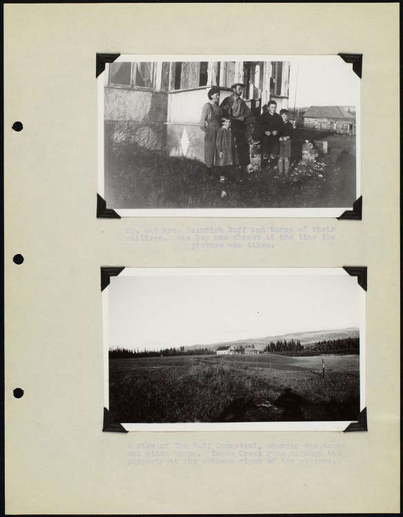 Page from an album with two black and white photographs; one showing a family standing in front of a house and the other showing a view of farmland. The photos are captioned with typed text.