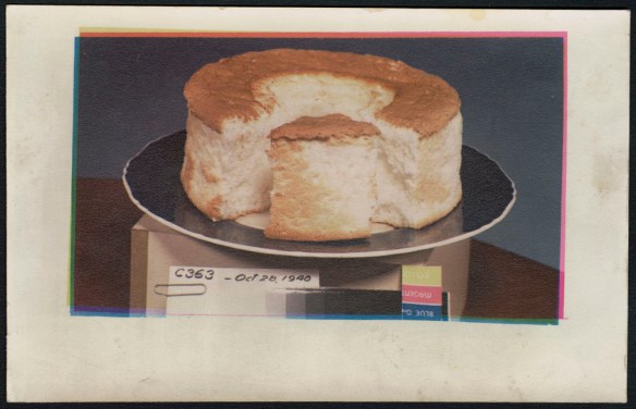 A print of a cut round cake on a black plate, situated atop a box bearing the printing matrix and creator number C363.
