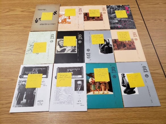 12 periodicals laying on a table. Attached to each periodical is a post-it-note written by Dr. Morgentaler identifying Canadian content in the issue. 