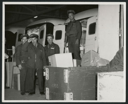 Three black-and-white photographs showing men dressed in uniforms beside Simpson’s delivery trucks, over the decades.