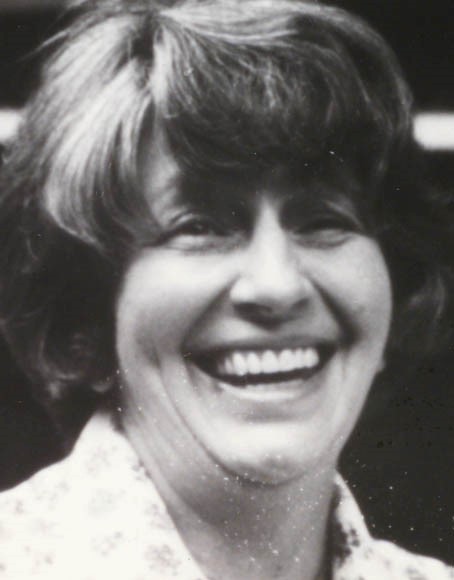 A black-and-white photograph of a smiling woman.