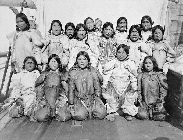 A black-and-white photo of 15 women and two babies, posed in three rows.