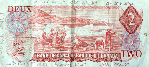 A colour photo of the back of the 1975–1979 Canadian $2 bill, on which the names of the six individuals depicted are written in syllabics.