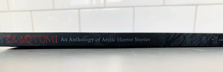 A colour picture of the spine of a black book with red and silver writing.