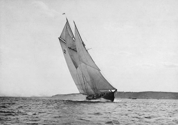 Black-and-white photograph of the Bluenose at the finishing line of a race.