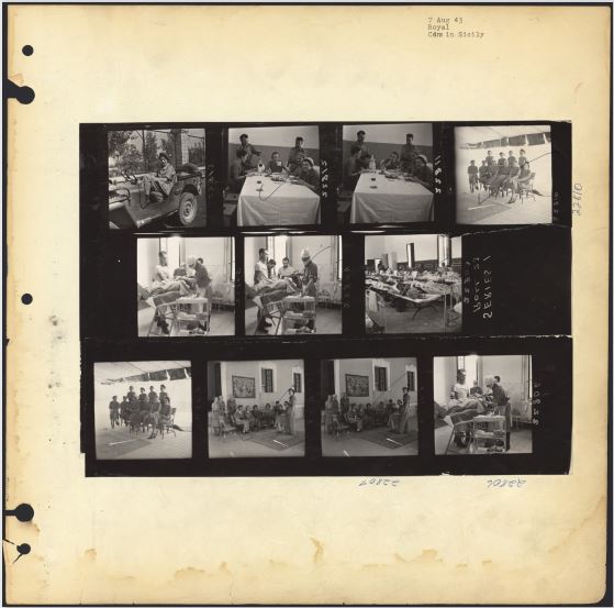 A page from a photo album with 11 black-and-white photographs and handwritten notations.