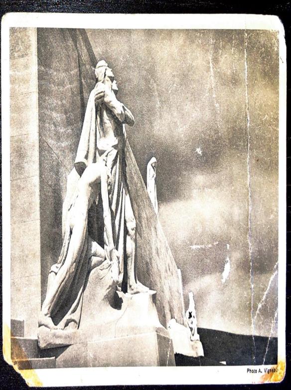 A sepia-tone image on the front of a postcard showing some stone figures of the Vimy Memorial.
