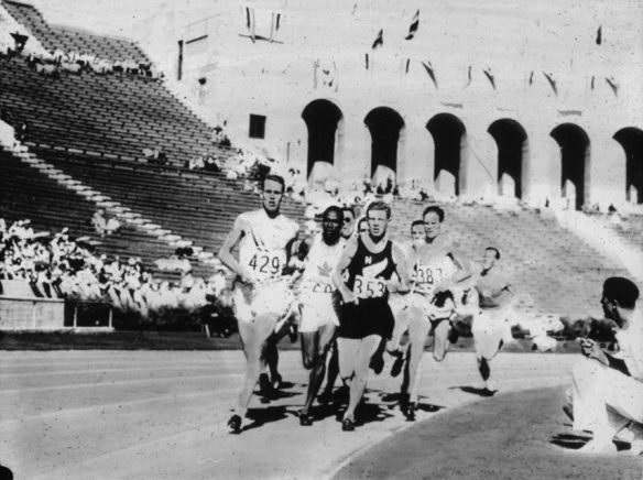 Several male athletes competing in a race.