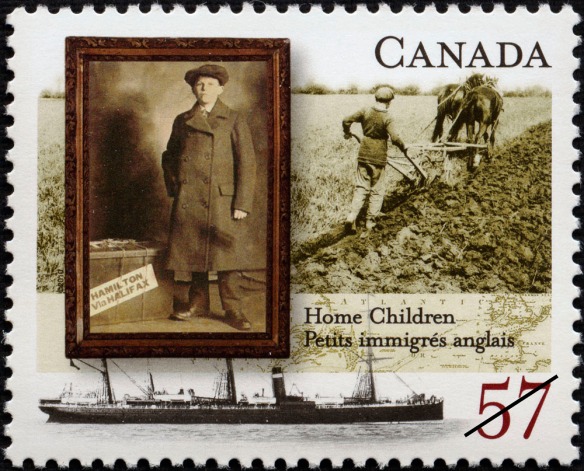 Postage stamp with a framed sepia photograph of a boy in a long coat with a suitcase, overlaid on a sepia photograph of a boy ploughing a field with two horses. There is a black-and-white photograph of a ship across the bottom of the stamp.