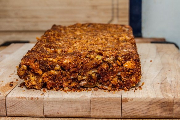 Cheese and walnut loaf on a wooden board.